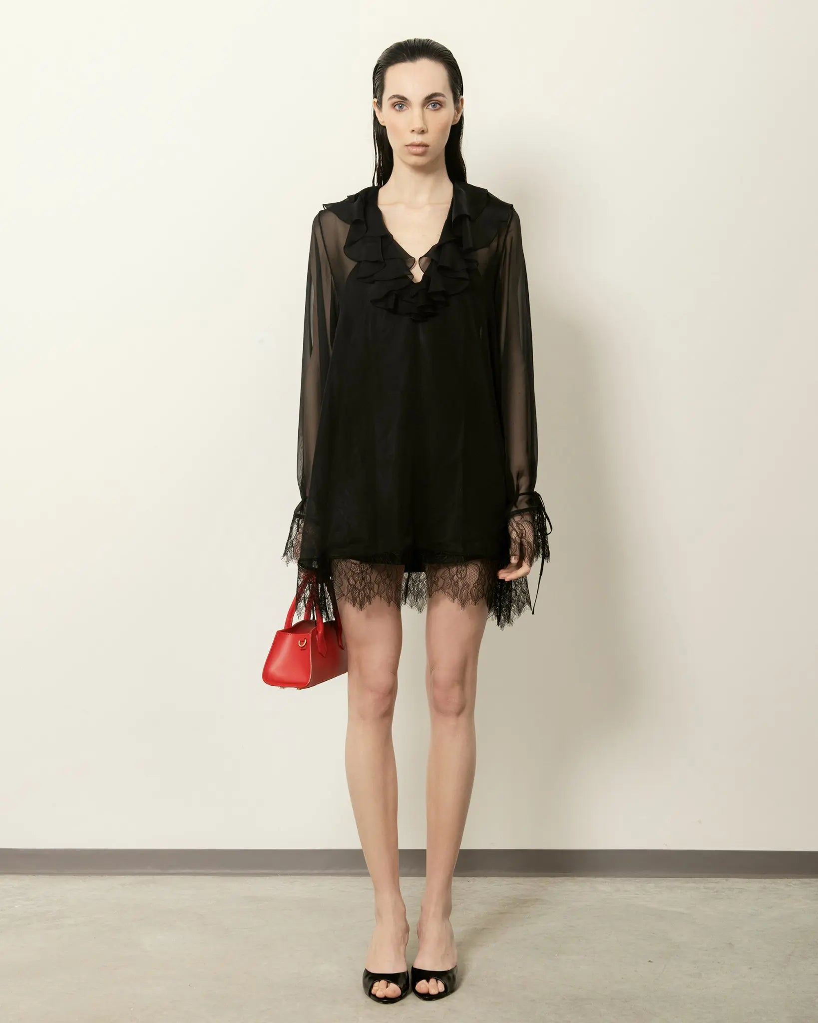 MADBAG Small Bassotto red leather handbag worn by model with black dress full body front view